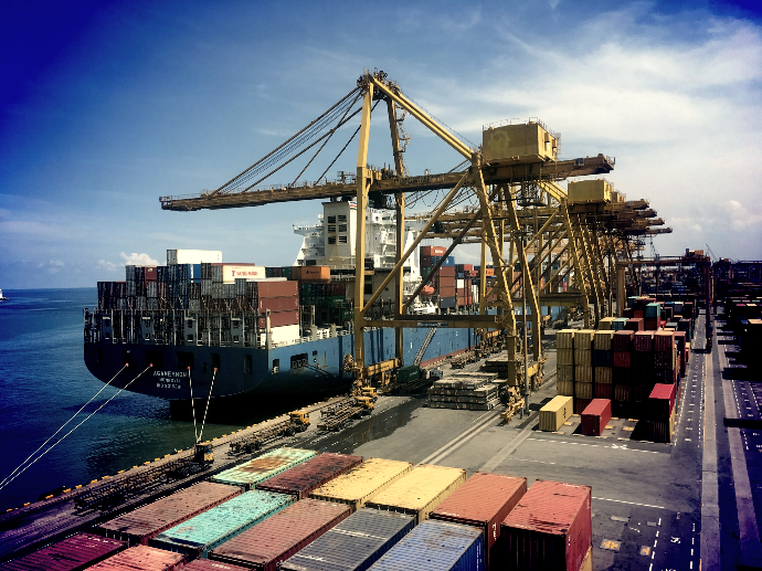 ship on dock near shipping containers